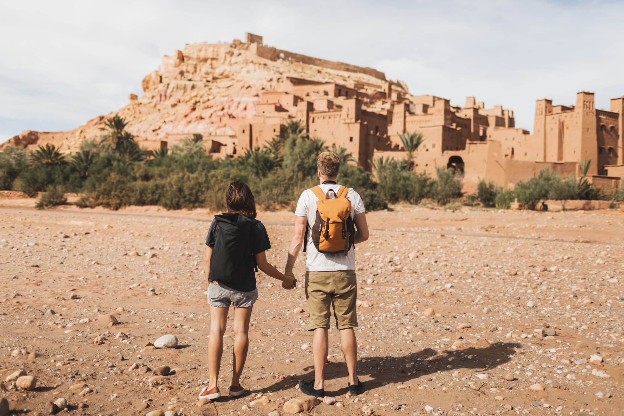 Pareja de viajeros contemplando la kasbah de Aït Ben Haddou, Patrimonio UNESCO de Marruecos